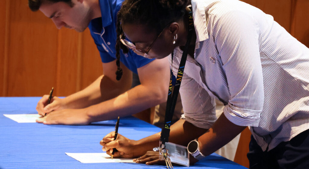 New PC students, faculty, and staff sign the Roll of Honor and pledge to adhere to the college's Honor Code.