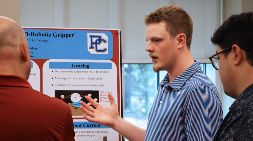 PC student Walton Bost discusses his summer research at the poster presentation for the 2026 Summer Research Symposium.