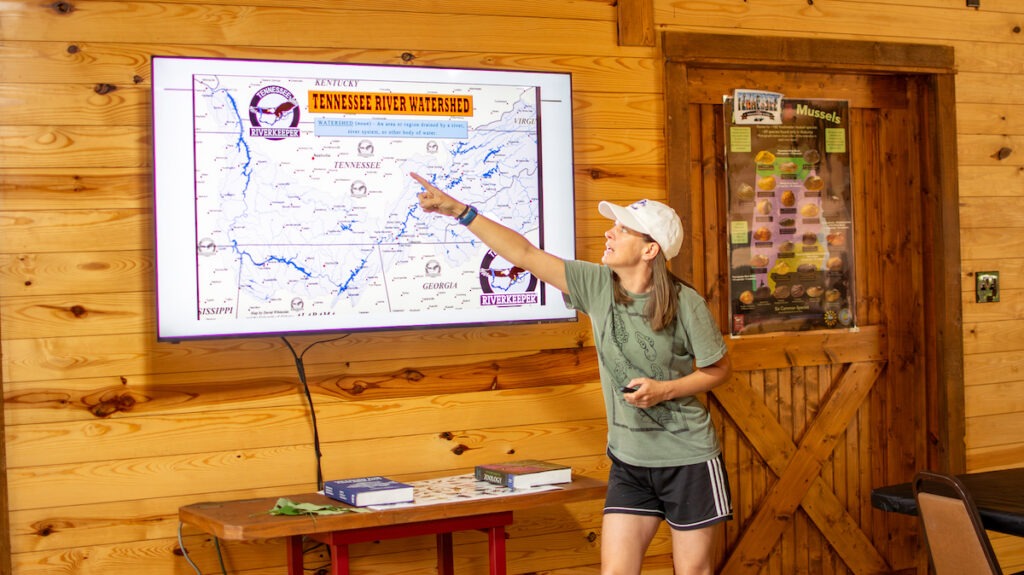 Assistant professor of biology Dr. Sabrina Moore discussing the Clinch River in Tennessee at the farm of Jim Samples, a fellow PC alum.