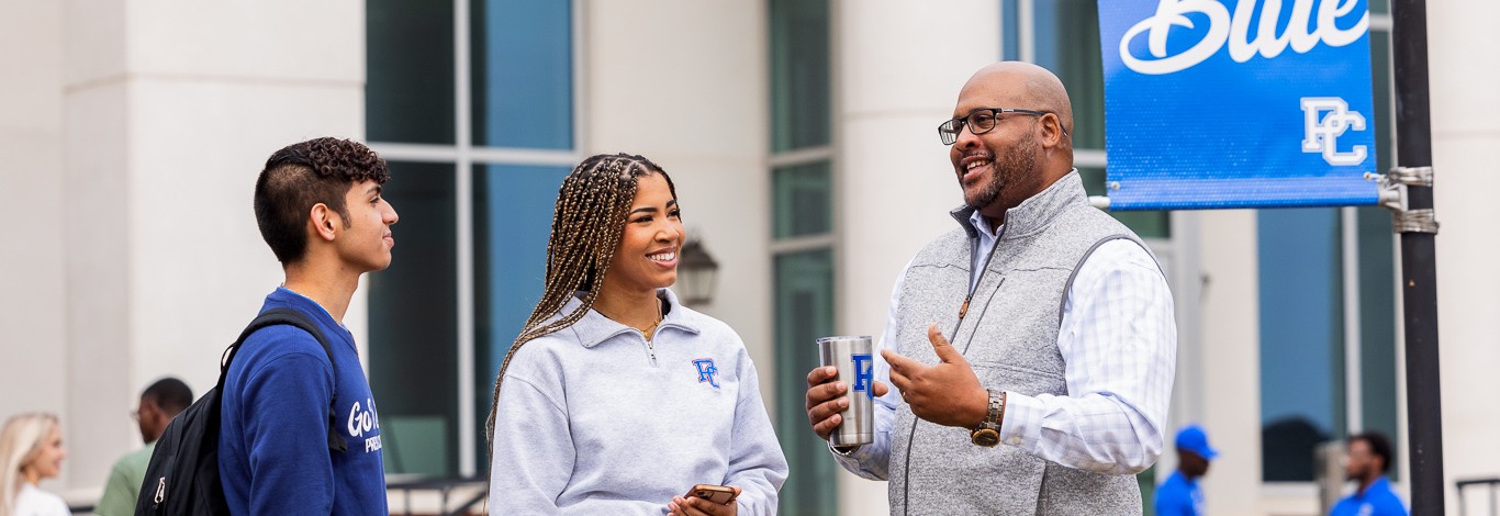 Students talking to Professor Harris in front of the Cornelson Center