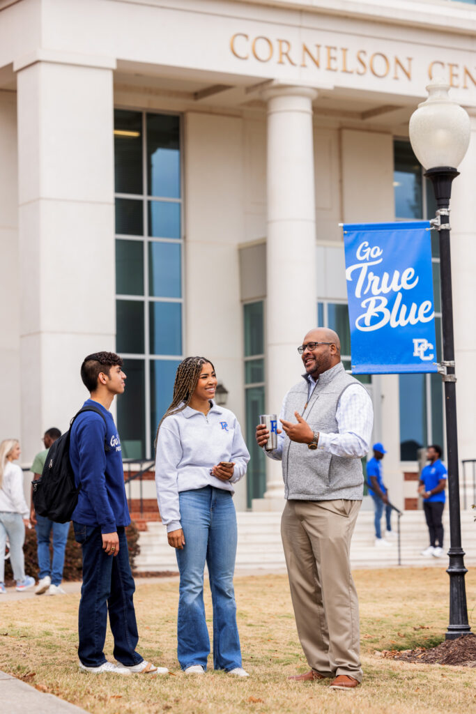 Dr. Will Harris with two students.