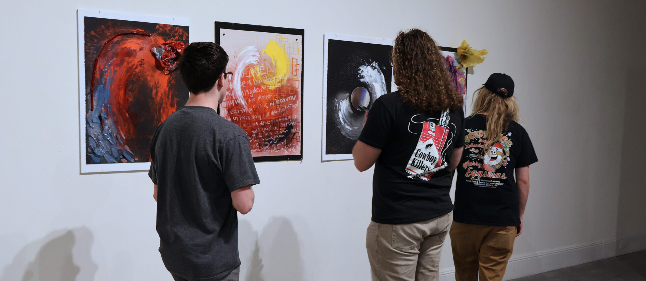 People looking at art at the Student Art Exhibit