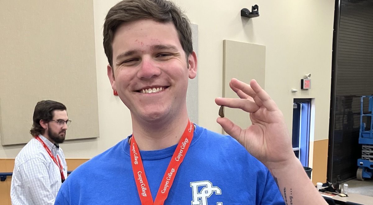 PC student Jeremiah Stichnoth '28 with a fossil find at the Tate Museum Conference in Casper, Wyo.