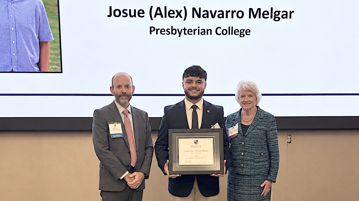 SCICU Student of the Year Alex Melgar '27 (center) is pictured with Ben Porter, SCICU board chair and PC president Dr. Anita Gustafson.