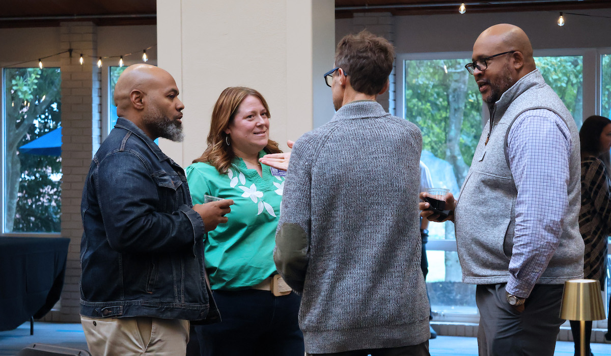 Dr. Will Harris and Dr. Justin Brent (right) talk to attendees at the regional NetVUE conference hosted by Presbyterian College.